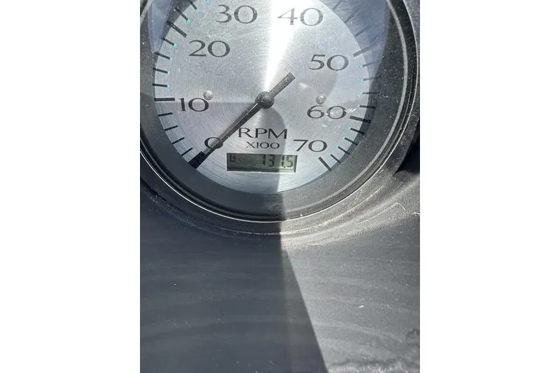 Slide: The Image of Close-up of a 2020 Bennington 21 SL RPM gauge displaying 1315 RPM. - 13