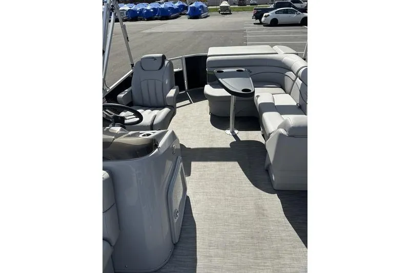 Slide: The Image of 2020 Bennington 21 SL pontoon boat interior with plush seating and steering console. - 14