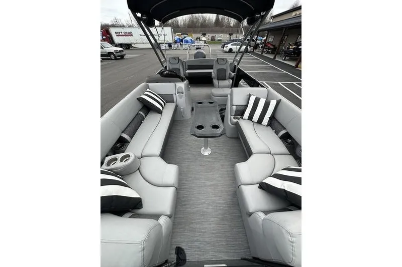 Slide: The Image of 2022 Bennington 24 LSBA pontoon boat interior with gray seating and striped cushions. - 10