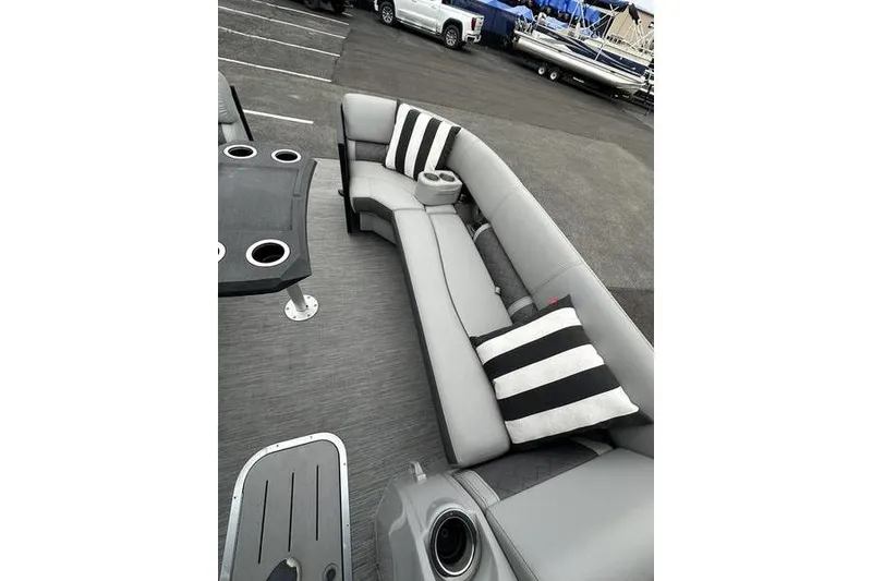 Slide: The Image of 2022 Bennington 24 LSBA pontoon boat with gray seating and striped cushions. - 14