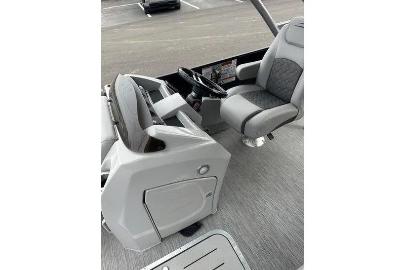 Slide: The Image of 2022 Bennington 24 LSBA boat interior with steering console and captain's chair. - 15