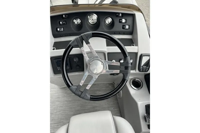 Slide: The Image of 2022 Bennington 24 LSBA boat dashboard with steering wheel and control panel. - 18