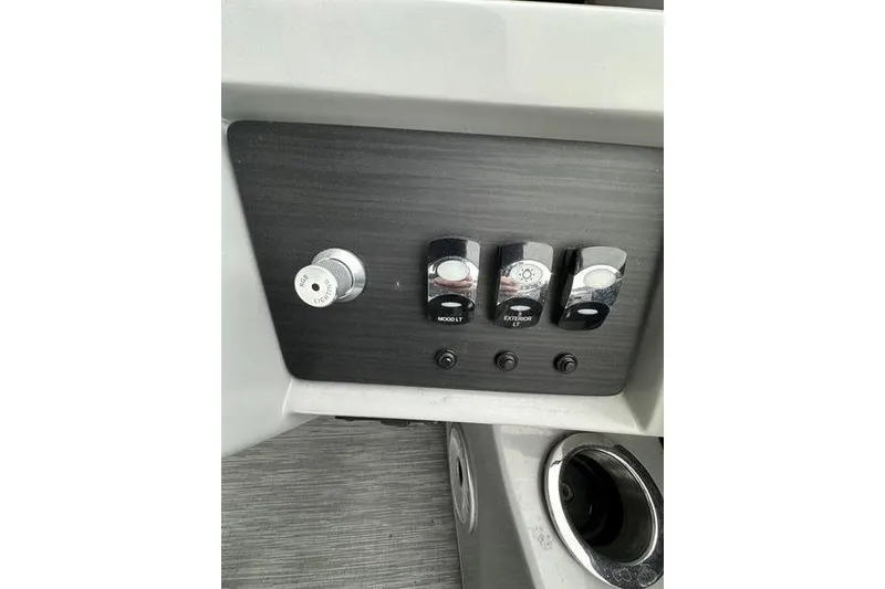 Slide: The Image of Control panel of 2022 Bennington 24 LSBA boat with switches and cup holder. - 20