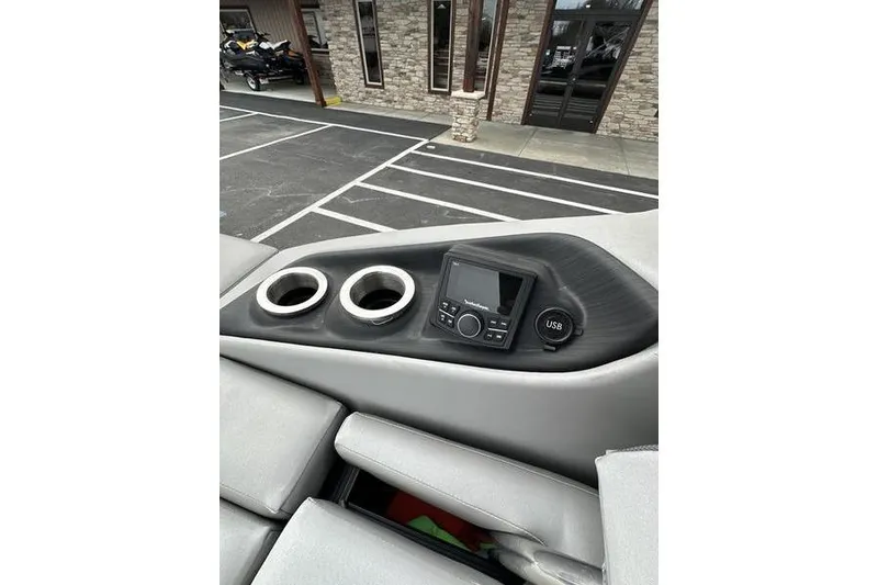 Slide: The Image of Dashboard of 2022 Bennington 24 LSBA boat with cup holders and USB port. - 25