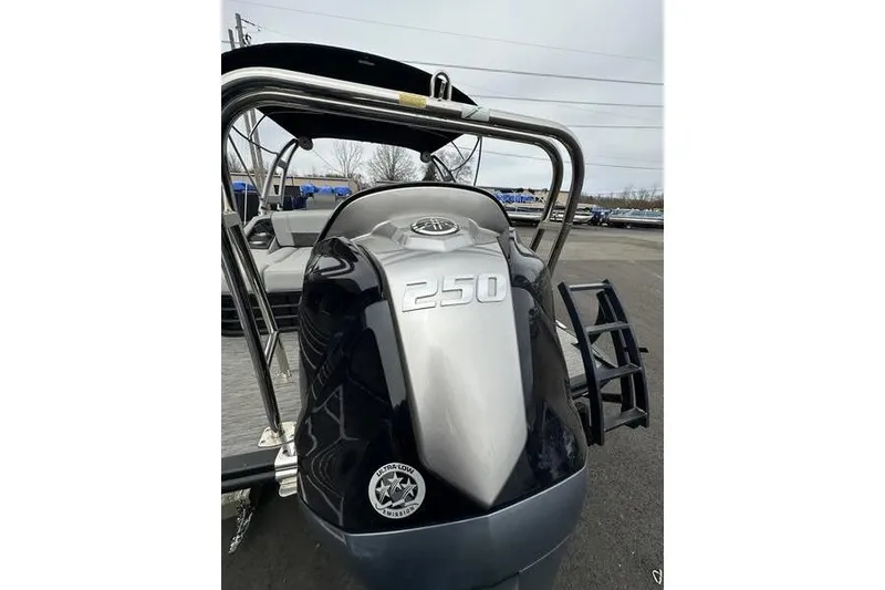 Slide: The Image of 2022 Bennington 24 LSBA boat with 250 horsepower engine, parked outdoors. - 6