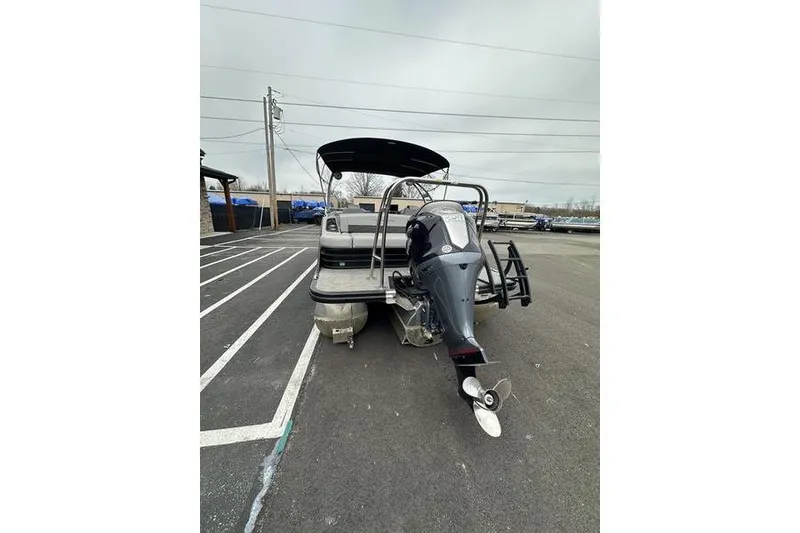 Slide: The Image of 2022 Bennington 24 LSBA pontoon boat with outboard motor in parking lot. - 7