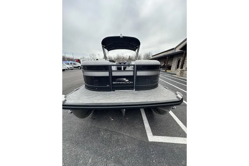 Slide: The Image of 2022 Bennington 24 LSBA pontoon boat parked outdoors on a cloudy day. - 8