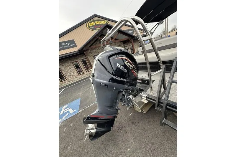 Slide: The Image of 2022 Bennington 24 LSBA boat with Yamaha outboard motor at dealership. - 9