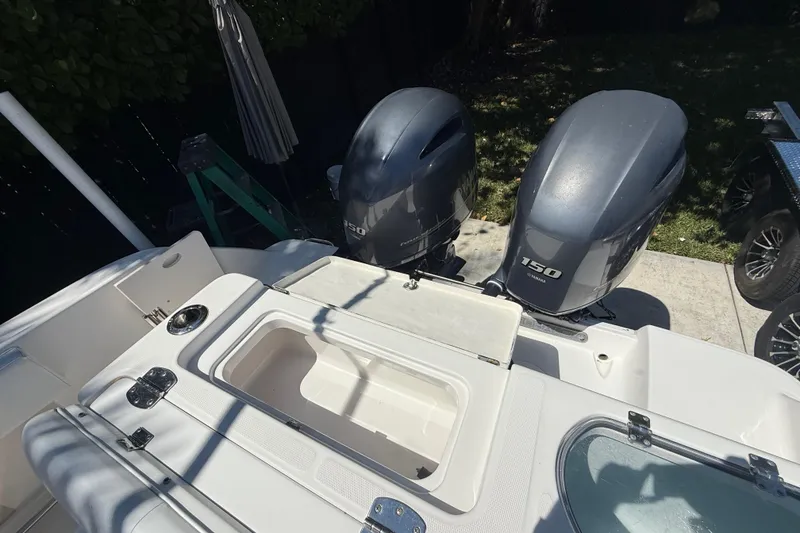 Slide: The Image of 2017 Robalo R242 Center Console boat with dual Yamaha 150 engines, open storage compartment. - 10