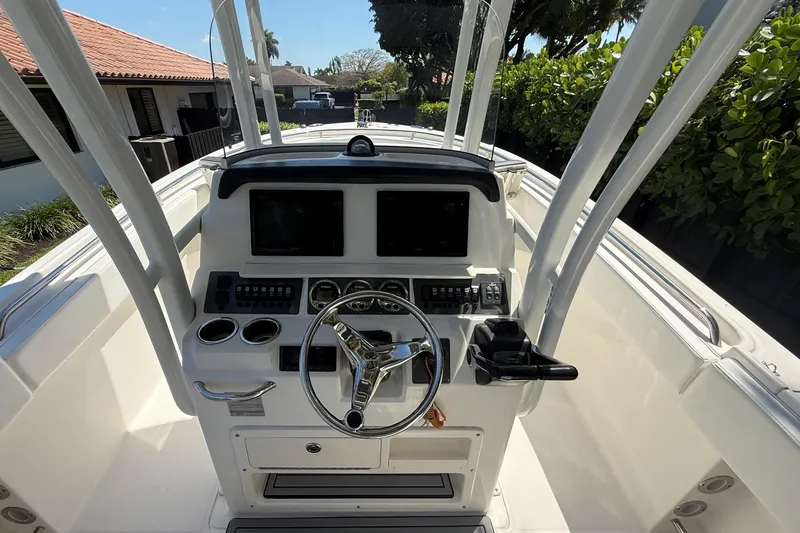 Slide: The Image of 2017 Robalo R242 Center Console helm with modern electronics. - 12