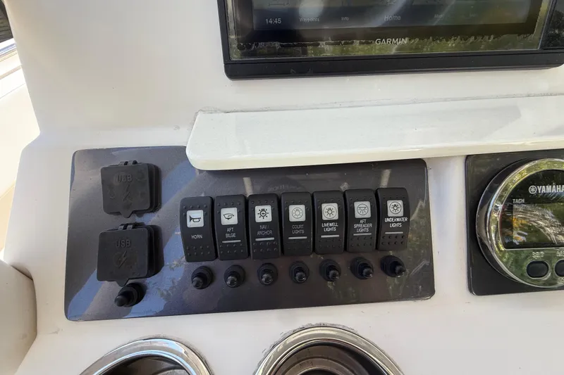 Slide: The Image of Control panel of 2017 Robalo R242 Center Console with switches and USB ports. - 15
