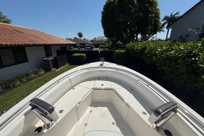 Slide: The Image of 2017 Robalo R242 Center Console boat in residential backyard setting. - 16