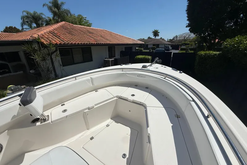 Slide: The Image of 2017 Robalo R242 Center Console boat in residential driveway, sunny day. - 18