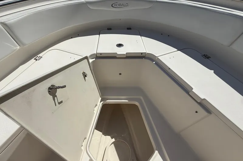 Slide: The Image of Open storage compartment in 2017 Robalo R242 Center Console boat. - 24