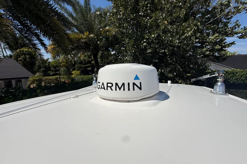 Slide: The Image of Garmin radar on 2017 Robalo R242 Center Console boat, surrounded by lush greenery. - 25
