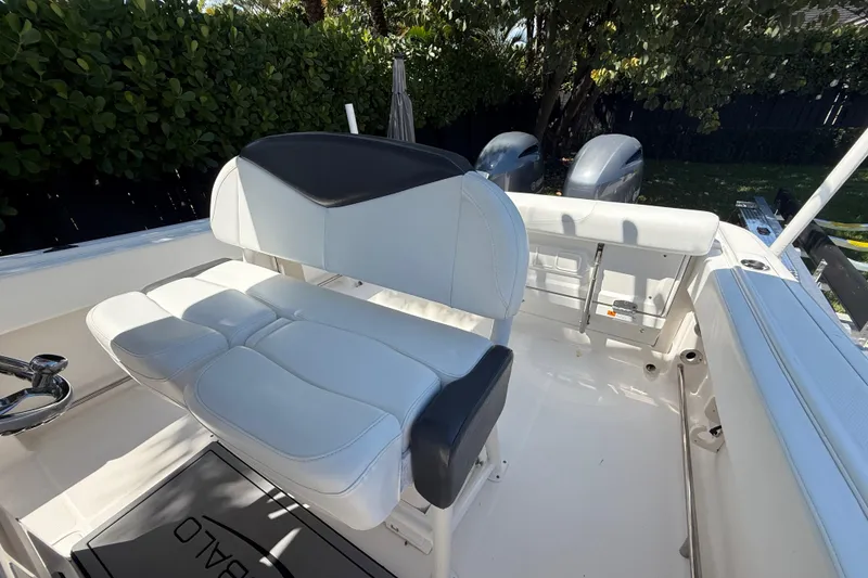 Slide: The Image of 2017 Robalo R242 Center Console boat interior with seating and dual engines. - 26