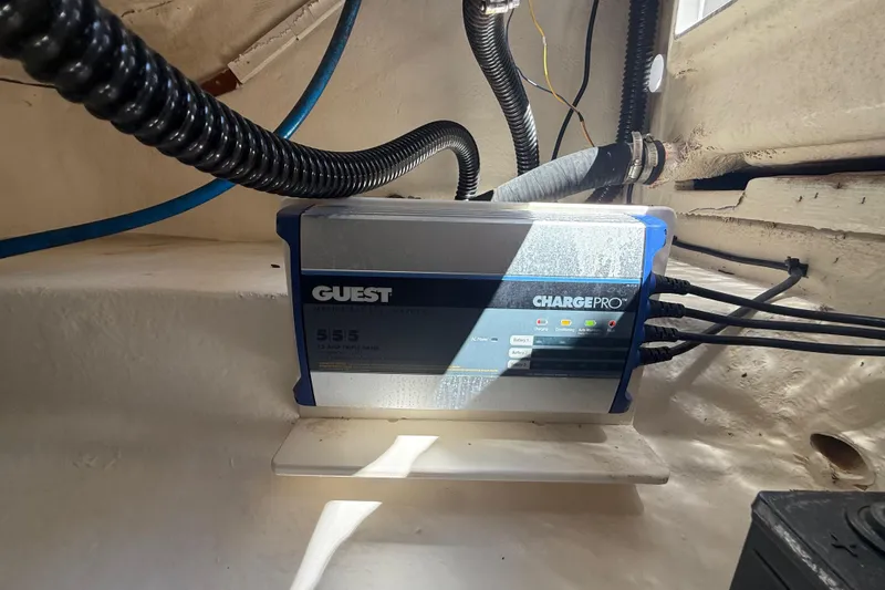 Slide: The Image of Battery charger in a 2017 Robalo R242 Center Console boat's compartment. - 27