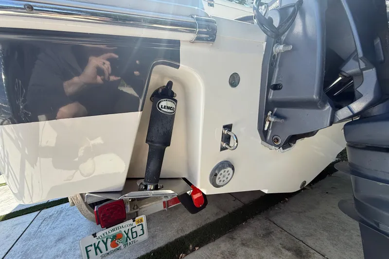 Slide: The Image of 2017 Robalo R242 Center Console boat stern with Lenco trim tab and Florida license plate. - 6
