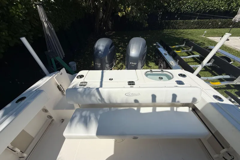 Slide: The Image of 2017 Robalo R242 Center Console boat with dual outboard motors and seating area. - 8