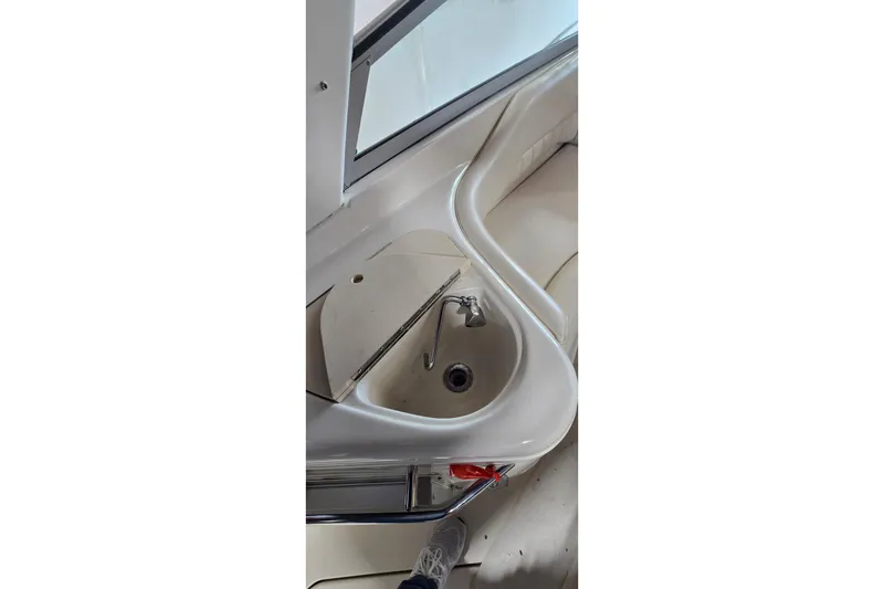 Slide: The Image of Interior view of a 2000 Monetery 302 Express boat featuring a compact sink area. - 12