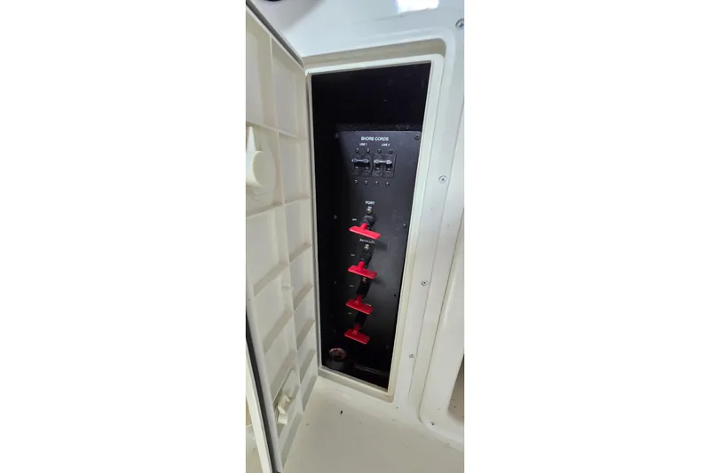 Slide: The Image of Electrical panel with red switches on a 2000 Monetery 302 Express boat. - 15