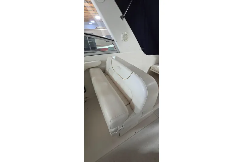 Slide: The Image of Interior seating of a 2000 Monetery 302 Express boat, featuring white upholstery. - 17