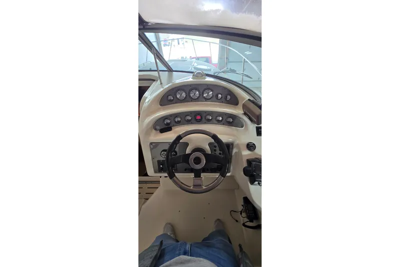 Slide: The Image of Cockpit view of a 2000 Monetery 302 Express boat with steering wheel and gauges. - 19