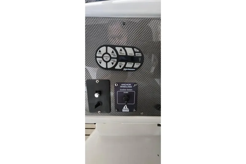 Slide: The Image of Control panel of a 2000 Monetery 302 Express boat with various switches and buttons. - 21