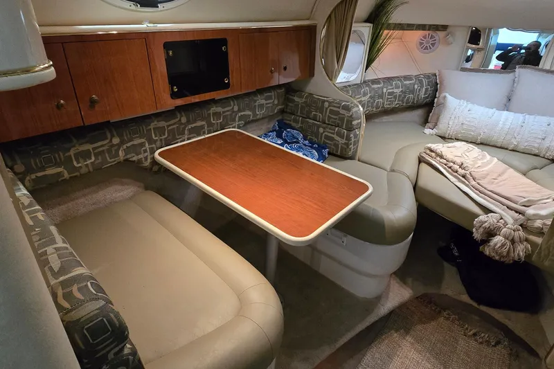 Slide: The Image of Cozy interior of a 2000 Monetery 302 Express boat with seating and table. - 25