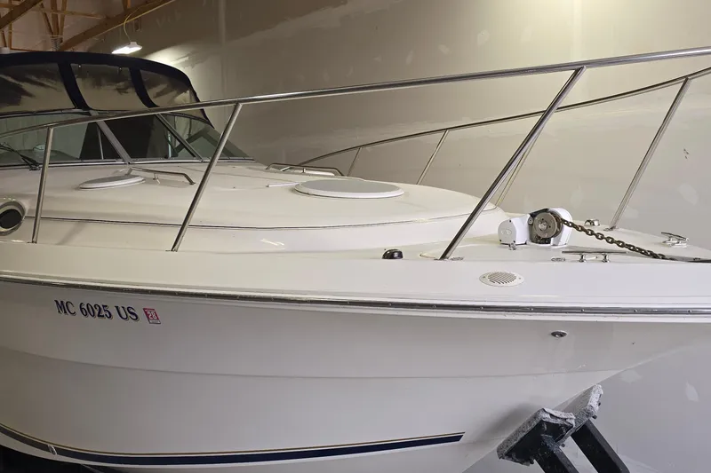 Slide: The Image of 2000 Monetery 302 Express boat in storage, featuring sleek design and sturdy railings. - 3