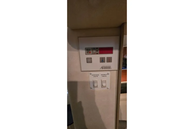 Slide: The Image of Control panel and light switches in a 2000 Monetery 302 Express boat interior. - 31