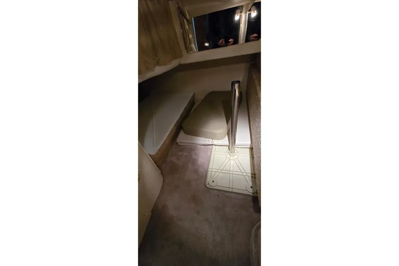 Slide: The Image of Interior cabin of a 2000 Monetery 302 Express boat, featuring seating and table setup. - 33