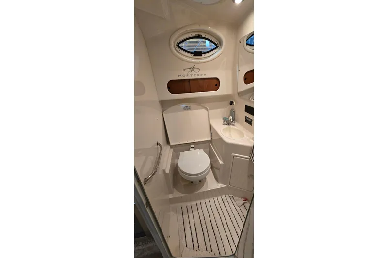 Slide: The Image of Bathroom interior of a 2000 Monterey 302 Express boat, featuring a toilet and sink. - 36