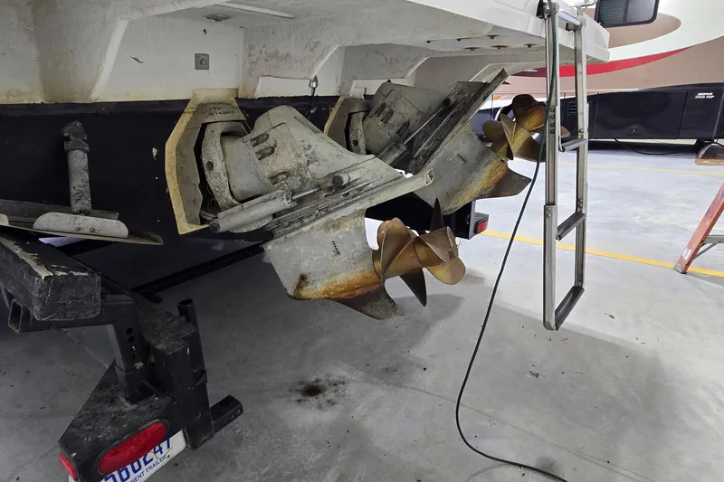 Slide: The Image of Rear view of a 2000 Monetery 302 Express boat with dual propellers in a garage. - 6