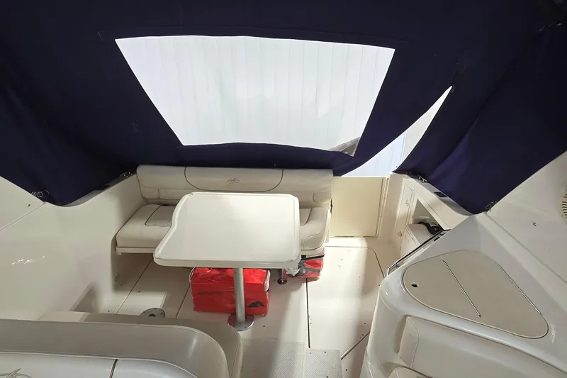 Slide: The Image of Interior of a 2000 Monetery 302 Express boat with seating and table. - 7