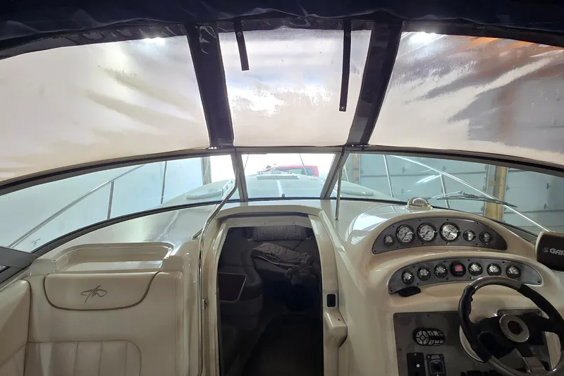 Slide: The Image of Interior view of a 2000 Monetery 302 Express boat cockpit with steering and instrument panel. - 8
