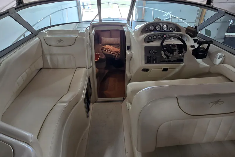 Slide: The Image of Interior of a 2000 Monetery 302 Express boat with steering console and seating area. - 9