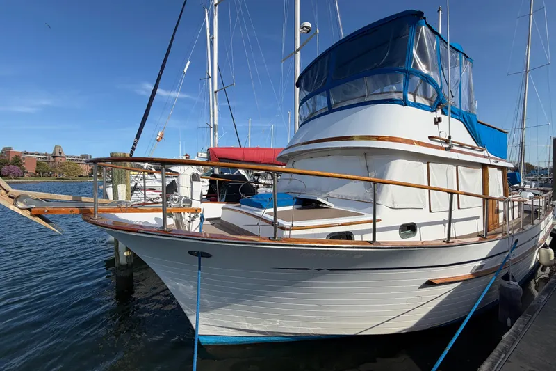 The Image of 1985 Albin 36 Trawler docked at a marina under clear blue skies. - 0