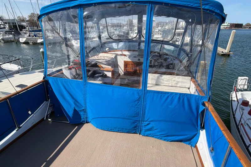 Slide: The Image of 1985 Albin 36 Trawler with blue canopy, docked at marina. - 10