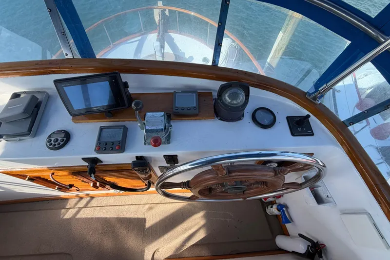 Slide: The Image of Helm of 1985 Albin 36 Trawler with navigation instruments and wooden steering wheel. - 13