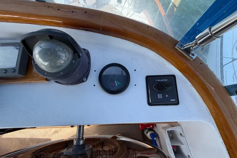 Slide: The Image of 1985 Albin 36 Trawler helm with compass, thruster control, and navigation instruments. - 14