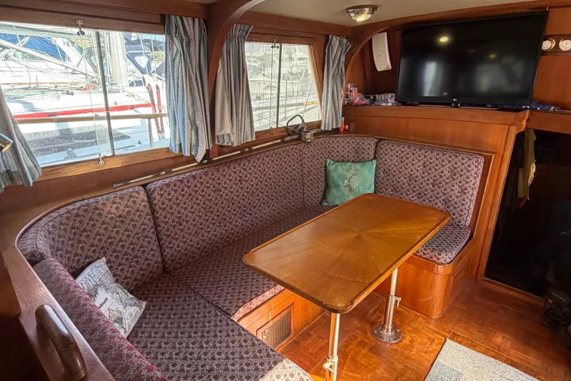 Slide: The Image of Interior of 1985 Albin 36 Trawler with cozy seating and wooden table. - 16