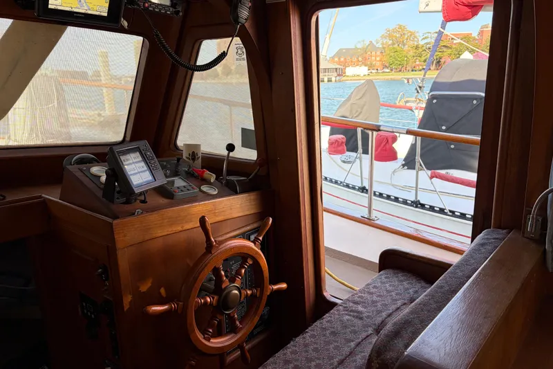 Slide: The Image of Interior view of 1985 Albin 36 Trawler helm with wooden wheel and navigation equipment. - 19