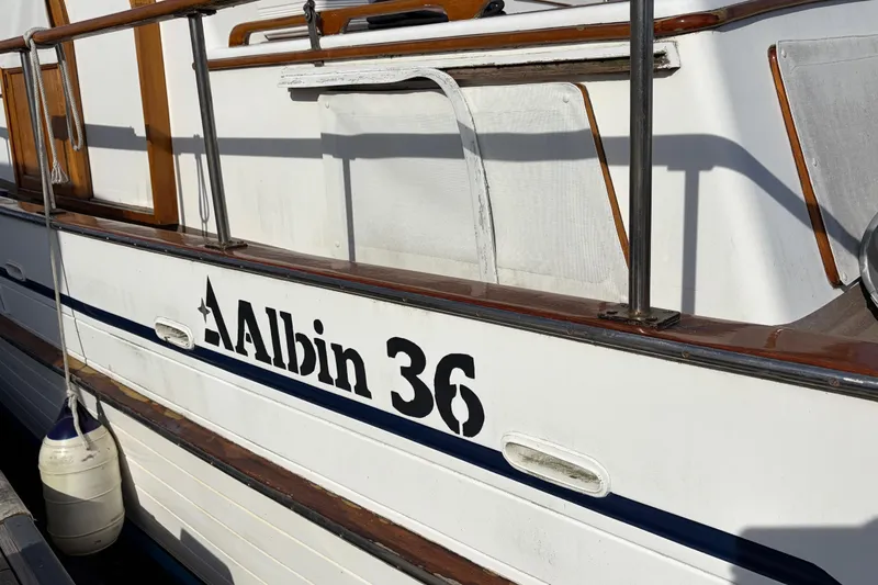 Slide: The Image of 1985 Albin 36 Trawler boat with wooden railings and visible logo. - 2