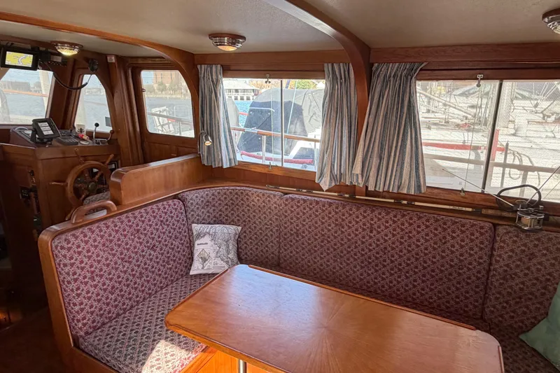 Slide: The Image of Cozy interior of 1985 Albin 36 Trawler with wood accents and patterned seating. - 20