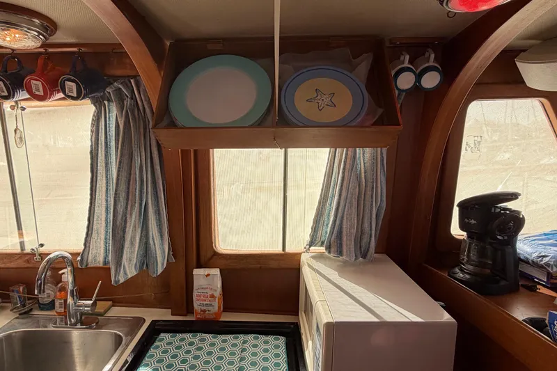 Slide: The Image of Interior of 1985 Albin 36 Trawler kitchen with sink, microwave, and coffee maker. - 23