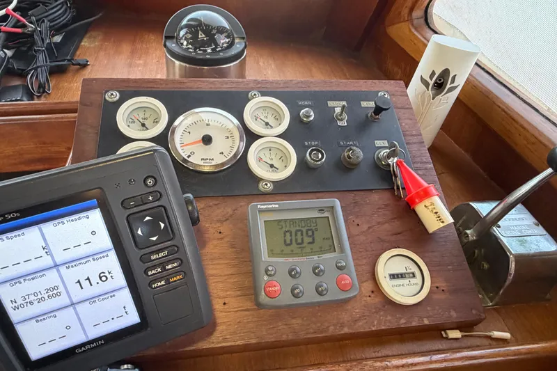 Slide: The Image of Control panel of a 1985 Albin 36 Trawler with navigation instruments and gauges. - 28