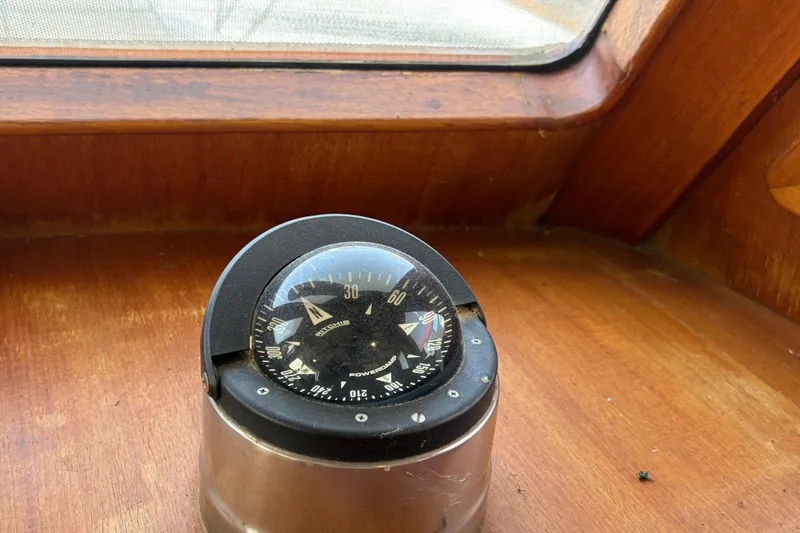 Slide: The Image of Compass on 1985 Albin 36 Trawler's wooden dashboard, near window. - 30