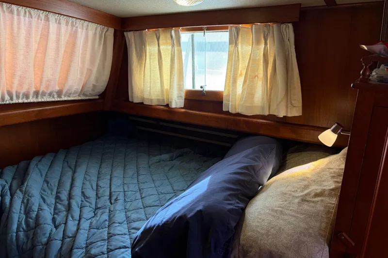 Slide: The Image of Cozy cabin interior of 1985 Albin 36 Trawler with bed and curtains. - 34
