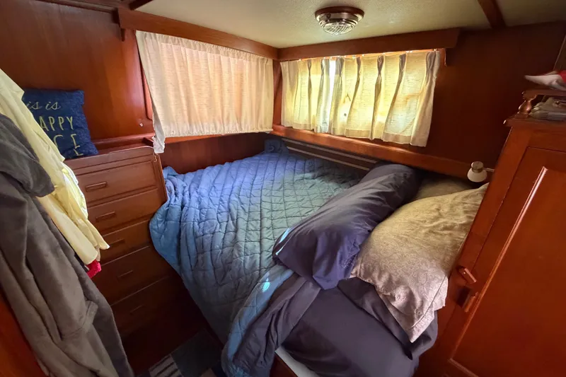 Slide: The Image of Cozy cabin bedroom in 1985 Albin 36 Trawler with wood paneling and soft lighting. - 35